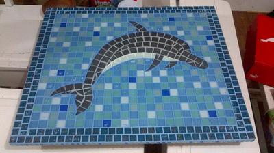 Table top with  a mosaic dolphin design